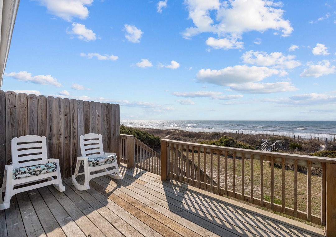 Relax in your private oceanfront deck chairs while taking in stunning sea views and coastal breezes from this perfect seaside retreat.