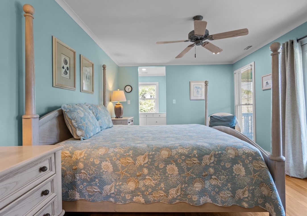Drift off in your serene coastal bedroom, where soft blue walls and ocean-themed bedding create your perfect seaside retreat.