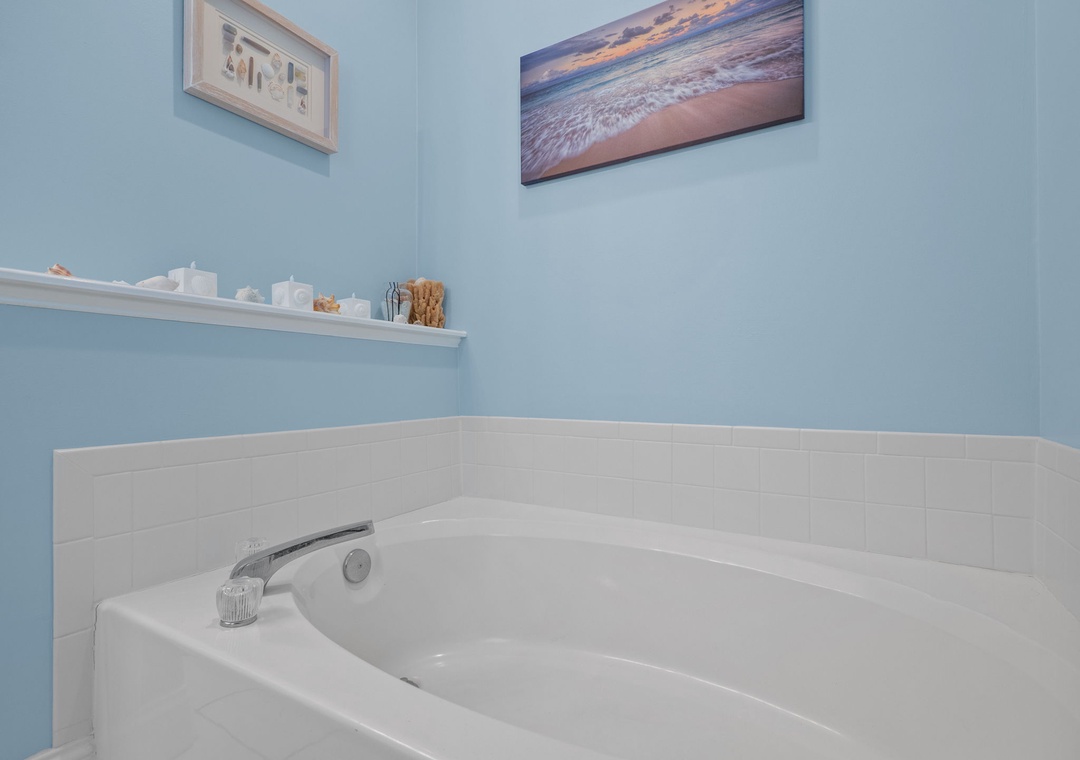 Slip into your private soaking tub surrounded by calming blue walls and coastal artwork for the perfect end to your day.