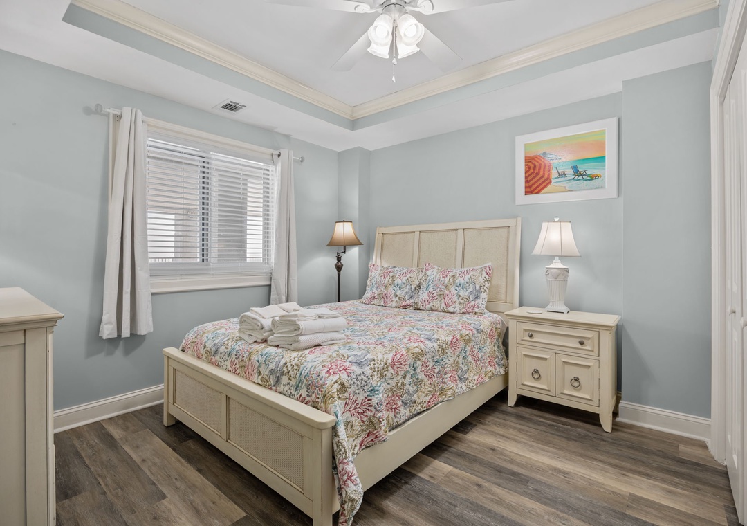 Settle into your peaceful bedroom sanctuary with coastal charm, soft linens, and gentle natural light filtering through the blinds.