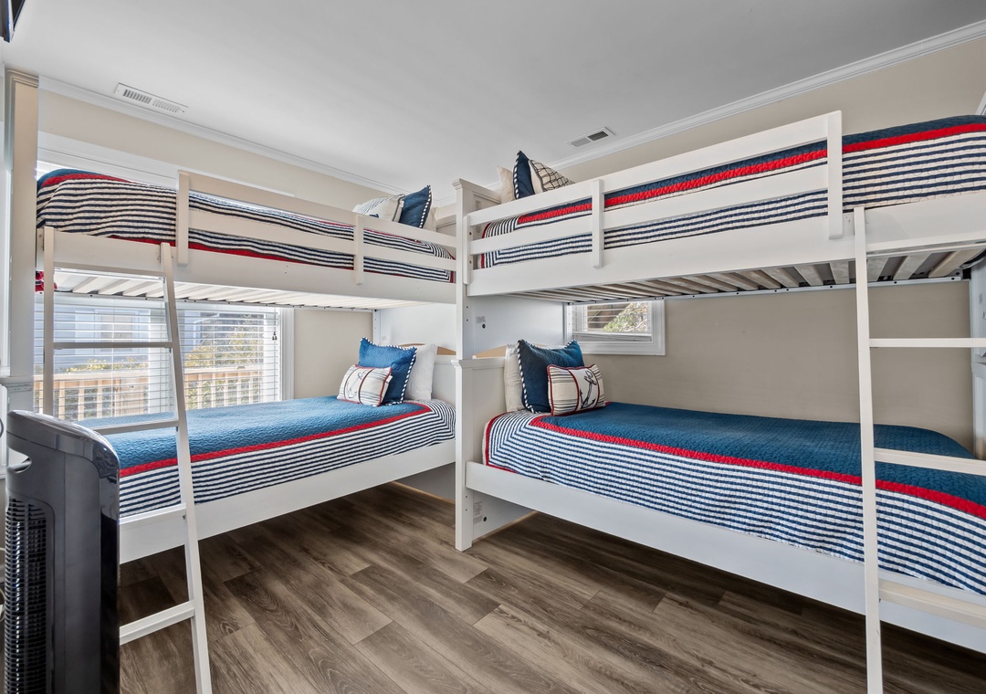 Your family will love this fun bunk room with crisp nautical bedding and city views through the windows.