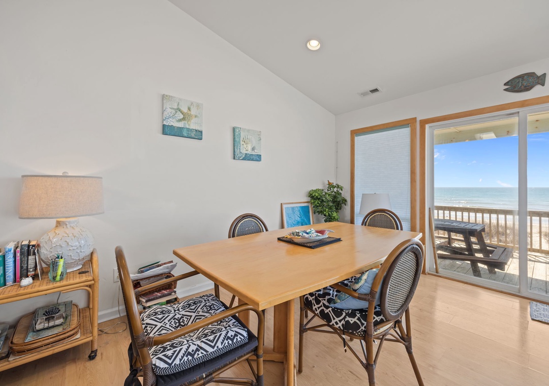 Gather around this welcoming dining table where ocean views frame every meal, creating the perfect backdrop for your coastal retreat conversations.