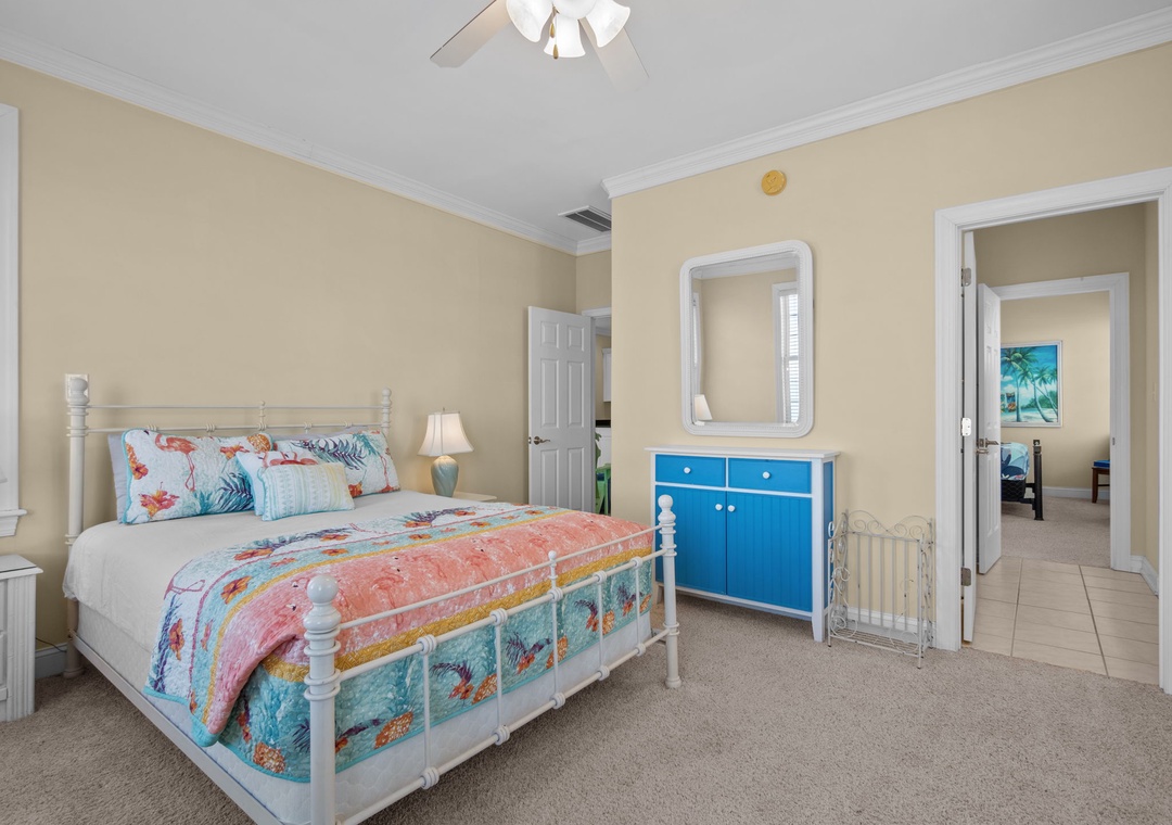 Drift off to dreamland in your cozy bedroom, complete with tropical bedding, gentle ceiling fan, and convenient crib for little ones.