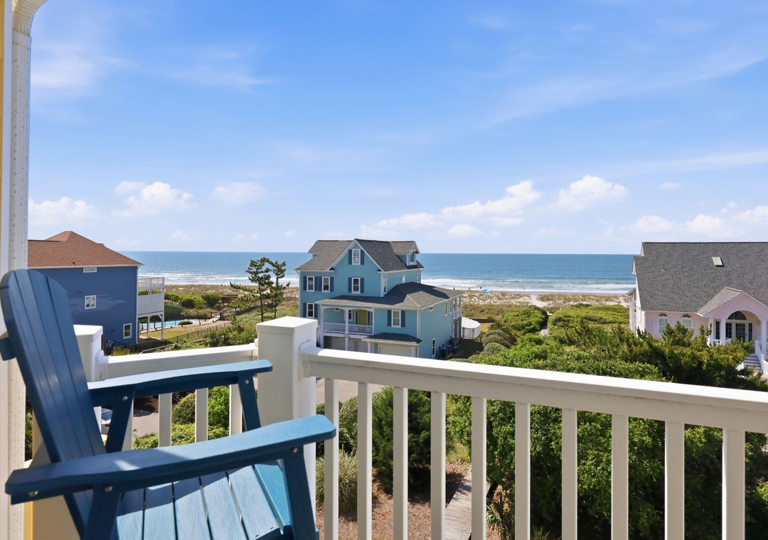 Relax on your private balcony with coastal views stretching to the ocean. Sip morning coffee as sea breezes drift over lush greenery and sandy shores just beyond.