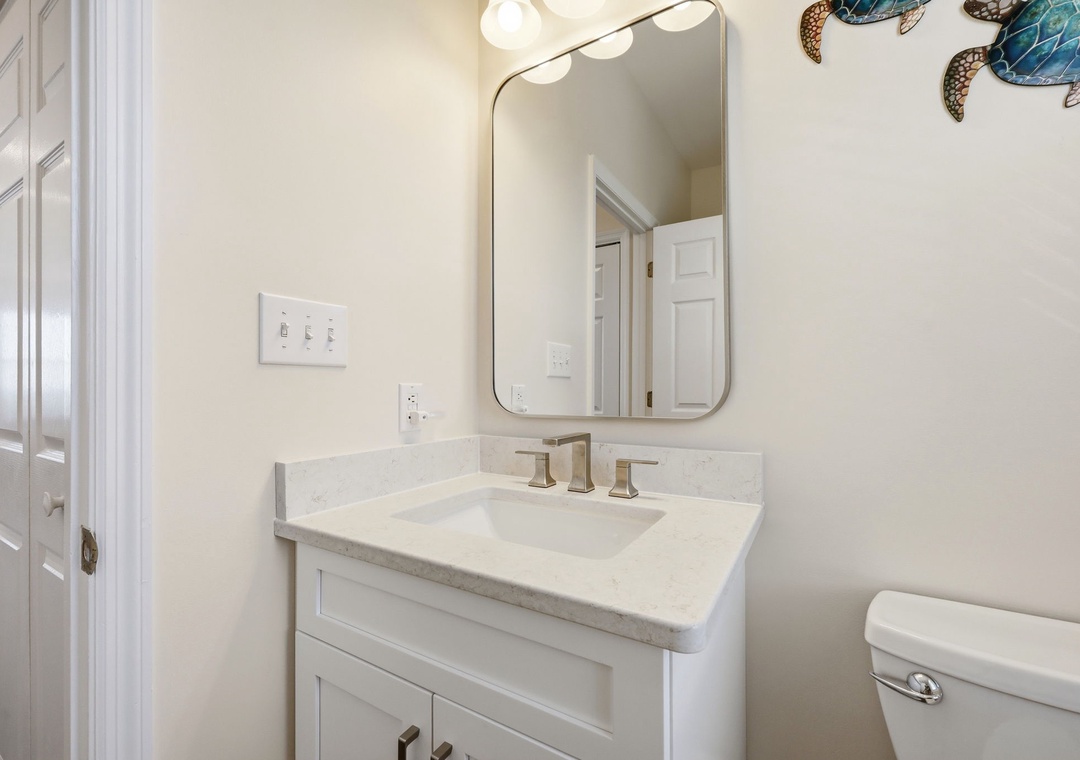 Your private bathroom features a marble vanity, modern fixtures, and coastal-inspired décor—a serene spot to refresh each morning.