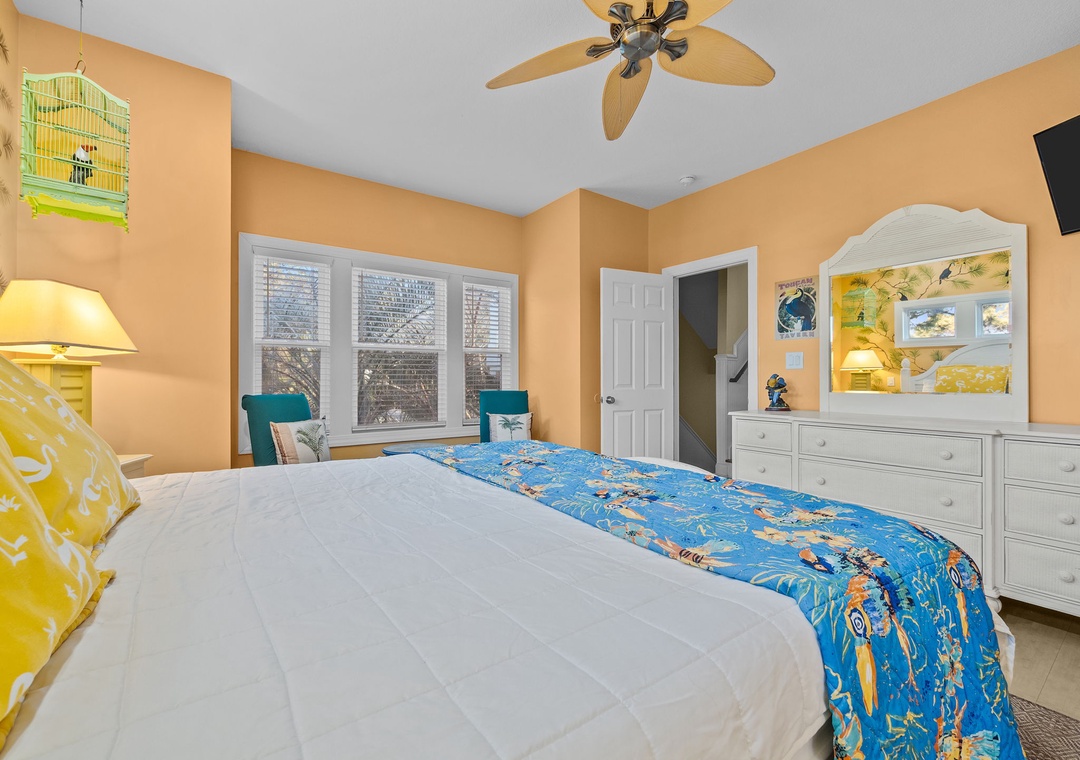 Your cozy bedroom features cheerful ocean-themed decor, a ceiling fan for comfort, and built-in entertainment center for relaxing evenings.