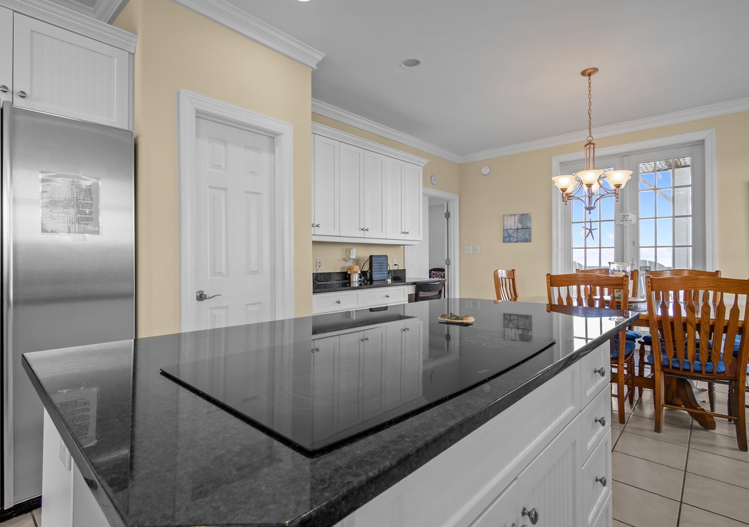 Your fully equipped kitchen features elegant granite countertops, stainless steel appliances, and a bright dining area perfect for preparing home-cooked meals together.