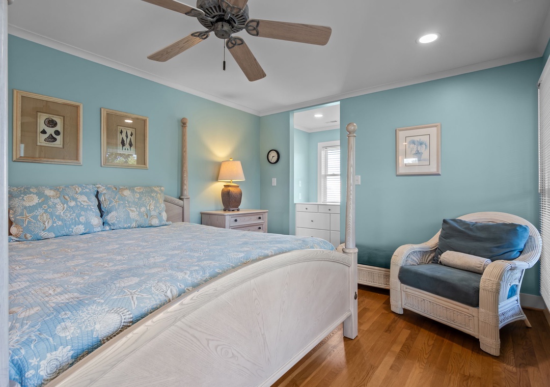 Drift off to sleep in your coastal-inspired bedroom, where soothing blue walls and the gentle whir of the ceiling fan create the perfect sanctuary for rest.