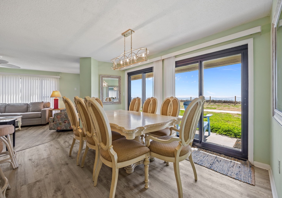 Gather around your elegant dining table where morning coffee and evening meals come with sweeping water views through floor-to-ceiling windows.