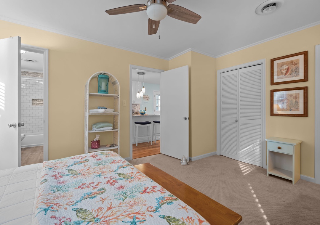 Relax in your comfortable bedroom with tropical bedding, built-in storage, and bright coastal decor that creates a peaceful retreat.