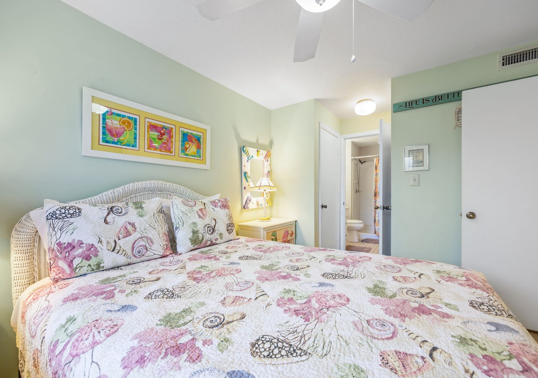 Drift off to sleep surrounded by cheerful florals and soft mint walls in this cozy bedroom with whimsical artwork.