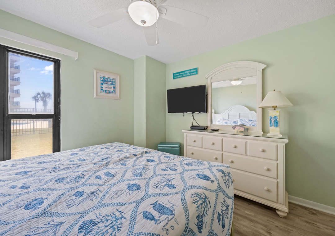 Your peaceful bedroom features soothing coastal colors and an ocean view window that brings natural light and sea breezes into your restful retreat.