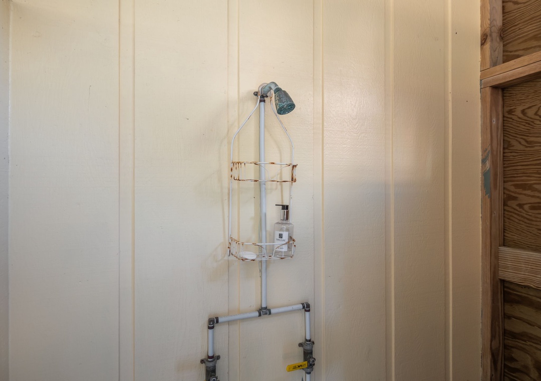Your private shower features a handheld showerhead and convenient caddy for toiletries.