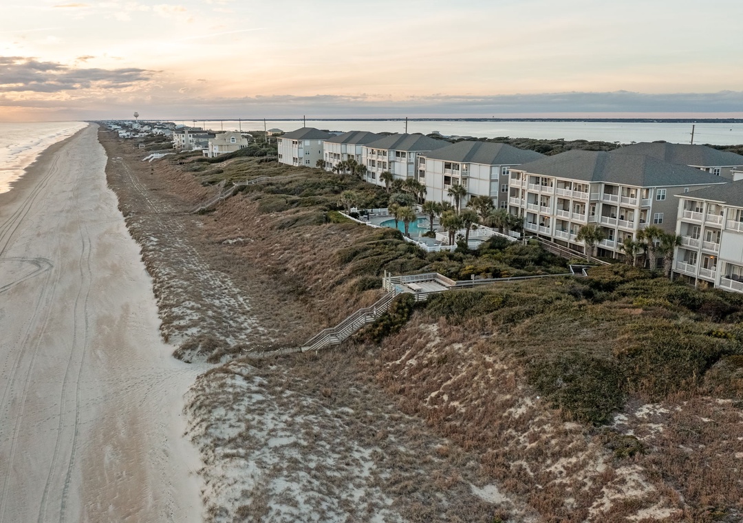 Beachfront resort nestled between pristine sandy shores and protected dunes, offering direct beach access and stunning coastal views.