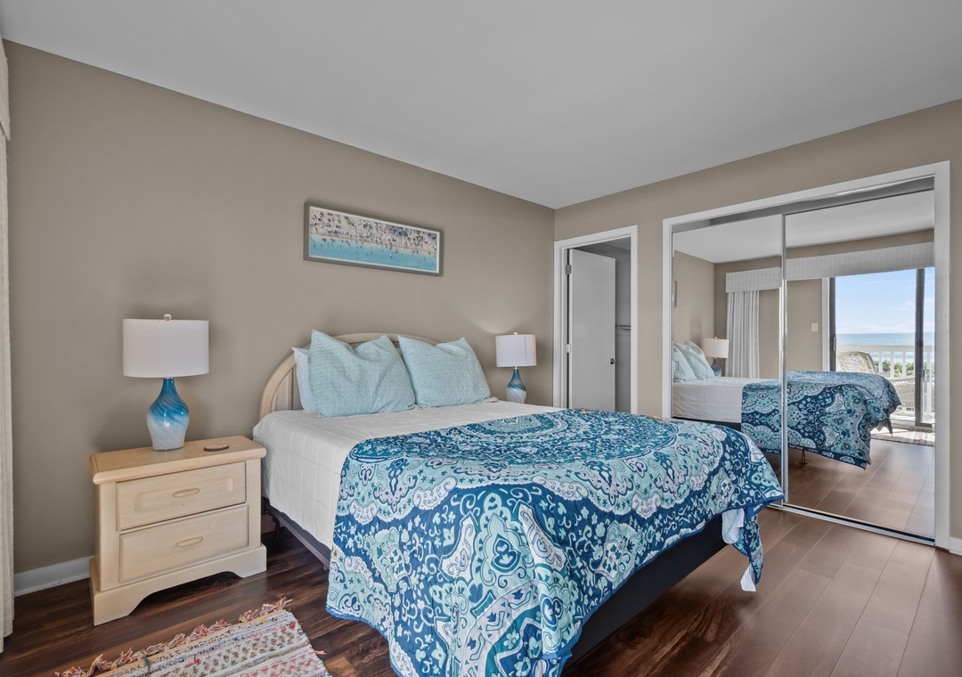 Sink into your tranquil bedroom where ocean-inspired décor and mirrored doors create a bright, airy sanctuary for restful nights.
