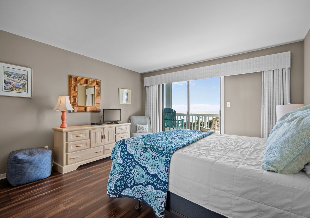 Wake up to stunning ocean views through your private balcony doors, with comfortable bedding and coastal décor creating your perfect beachside retreat.