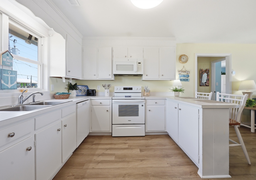 Picture yourself preparing fresh morning coffee in this bright, welcoming kitchen with ample counter space and everything you need for home-cooked meals during your stay.