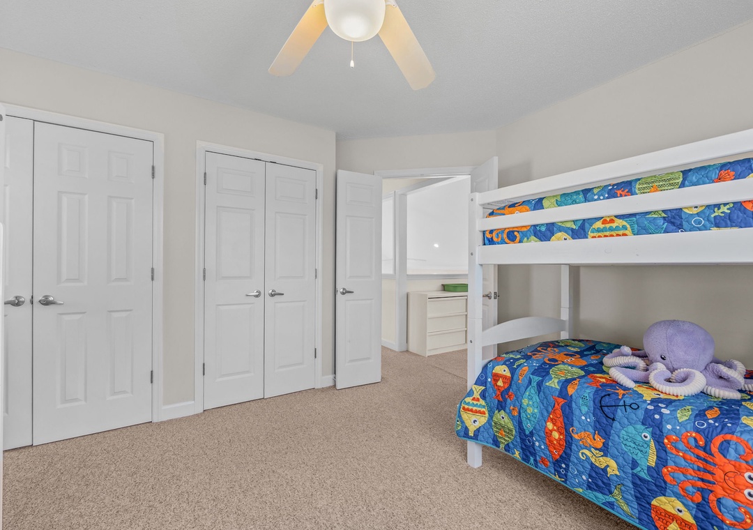 Your kids will love this cheerful bunk room with colorful ocean-themed bedding and plenty of storage space for all their treasures.