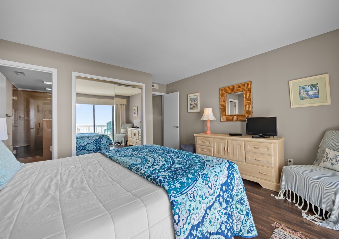Drift into comfort in your spacious bedroom with plush bedding, modern furnishings, and a cozy reading chair—your perfect retreat.