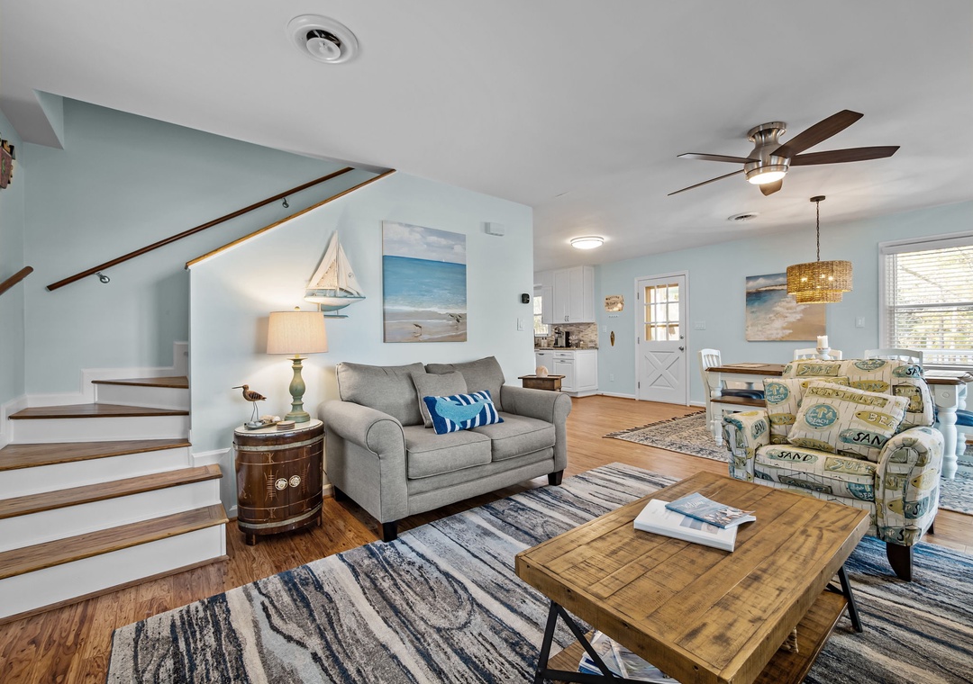 Unwind in your coastal living room featuring comfortable seating, nautical decor, and bright open-concept design perfect for relaxing.