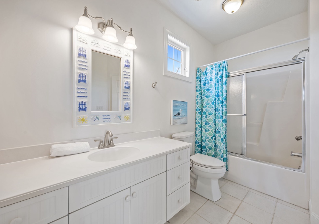 Step into your bright, coastal-themed bathroom with crisp white finishes and cheerful turquoise accents that make every morning feel refreshing.