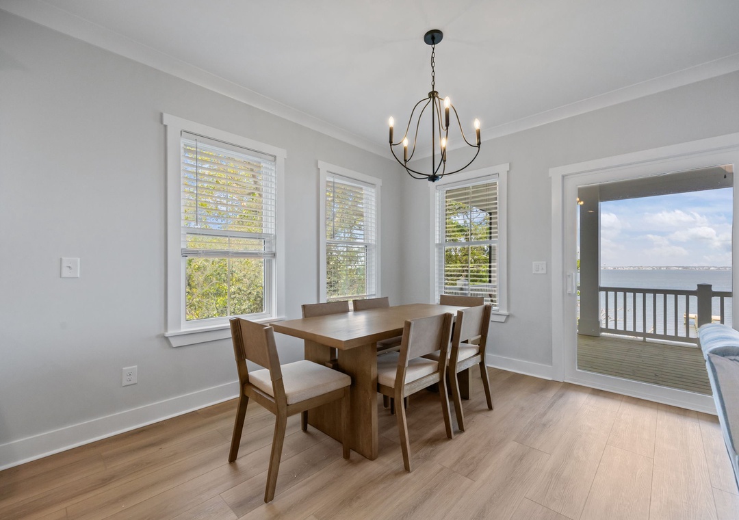 Gather around this elegant dining table for memorable meals while enjoying stunning water views through the open balcony doors.