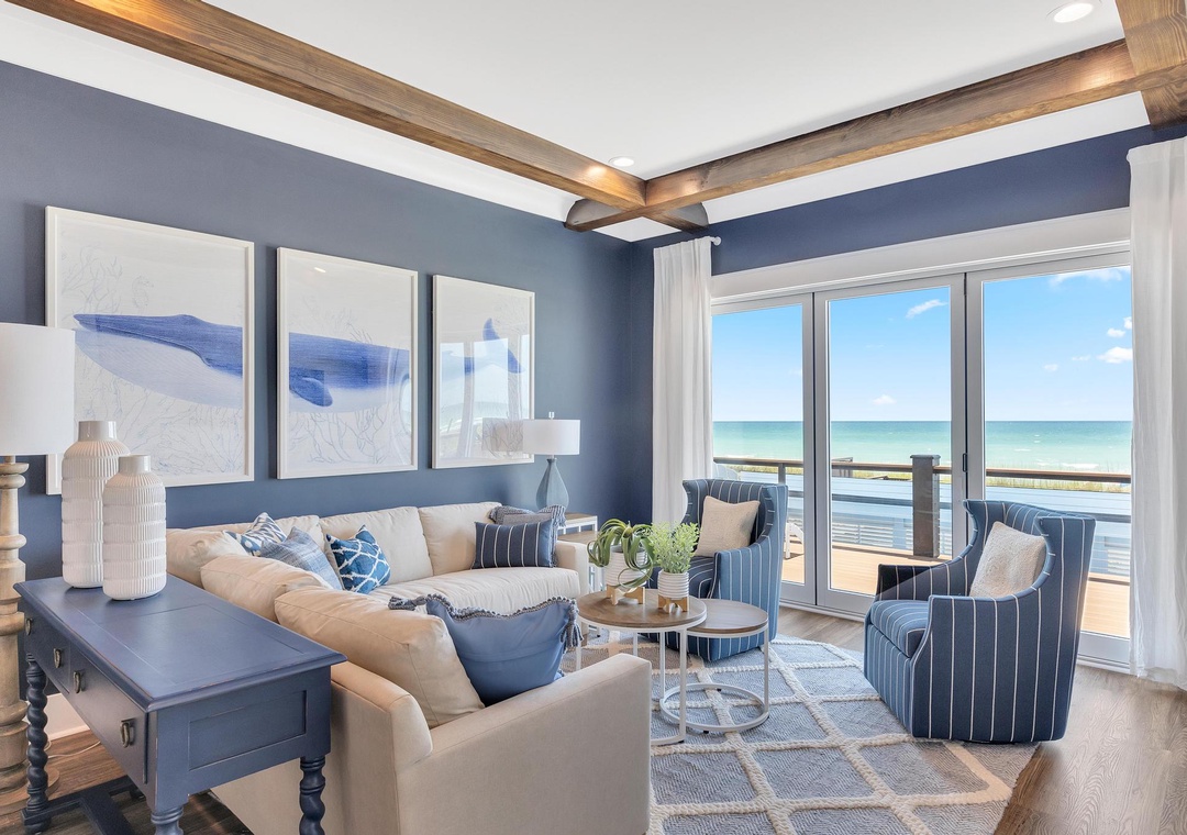 Step into this elegant living room where coastal blues and crisp whites meet warm wood accents. Your private sea-view terrace invites you to relax while soft textures create a soothing escape.