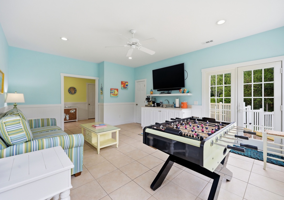 Step into your private game room where friendly competition awaits. Challenge your family to foosball, relax on comfy seating, catch a movie on the wall-mounted TV, or slip outside to your deck through elegant French doors.
