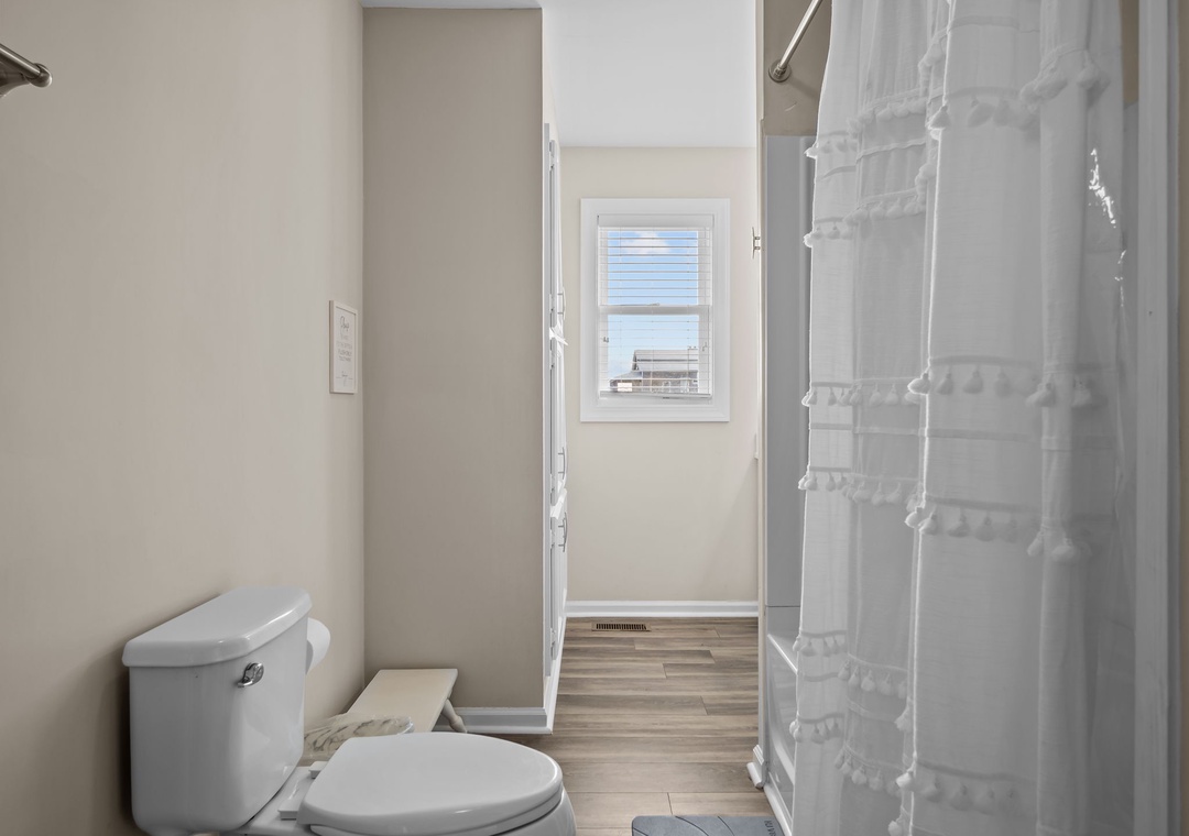 Step into your private bathroom featuring a clean, modern design with fresh linens and natural light streaming through the window.
