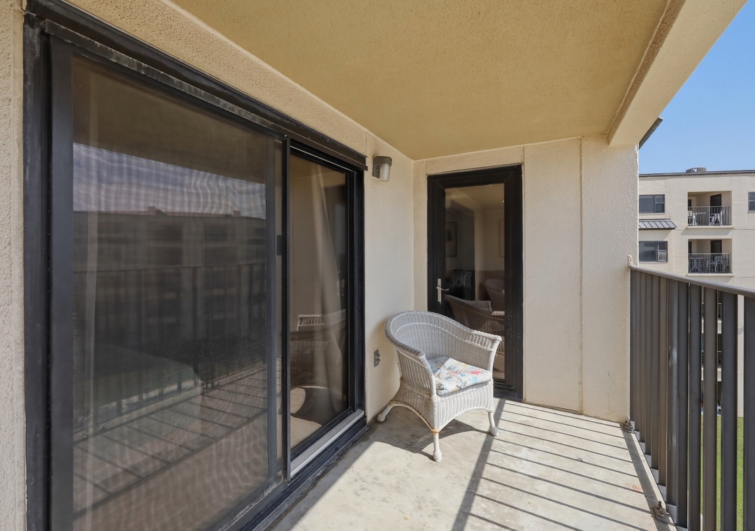 Step onto your private balcony where a cozy wicker chair waits for you to soak in the sunshine and fresh air, perfect for morning coffee or evening relaxation.