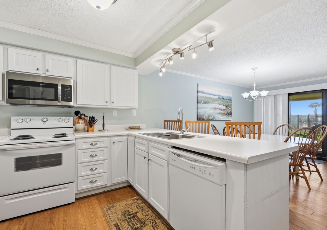 Your fully equipped kitchen opens to a sunlit dining space where meals and memories come together. Bright counters, modern appliances, and a welcoming island invite you to cook and gather with ease.