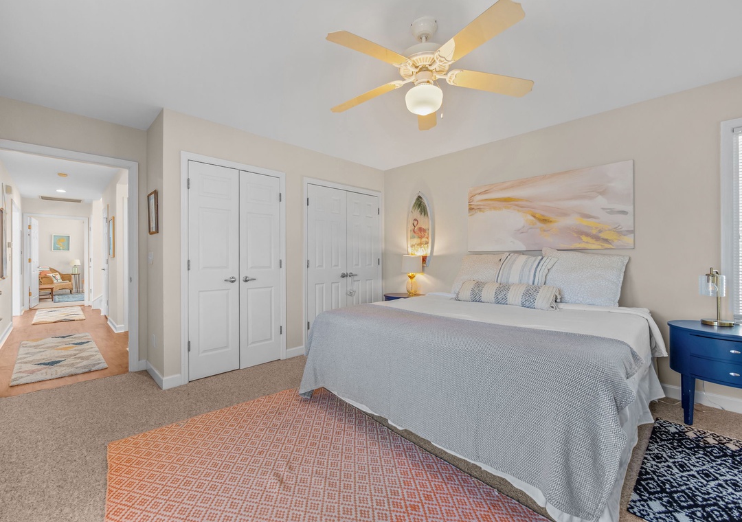 Drift off to sleep in your cozy bedroom featuring a plush queen bed, soft linens, and gentle ceiling fan to keep you comfortable throughout the night.