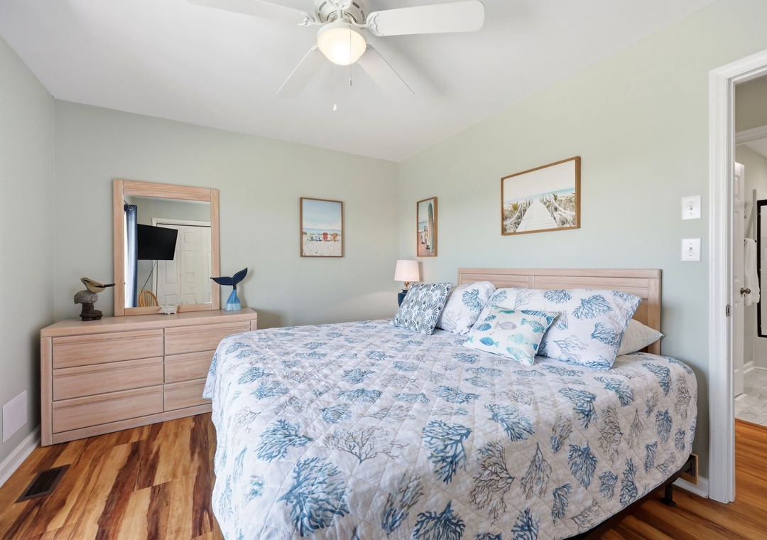Settle into your peaceful retreat with soft coastal bedding, warm wood tones, and a ceiling fan to keep you comfortable. Beach-inspired decor and gentle hues create a soothing escape after your adventures.