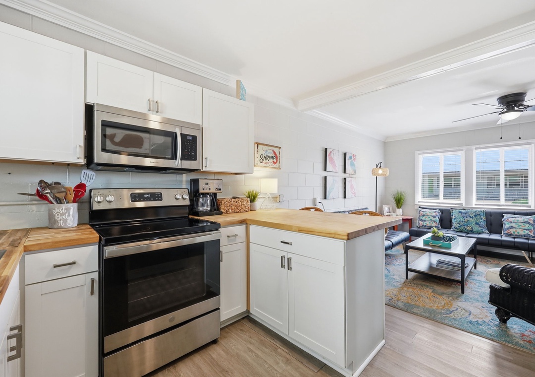 Bright, open-concept space where you can whip up meals in the fully equipped kitchen while chatting with friends relaxing in the adjacent living room.