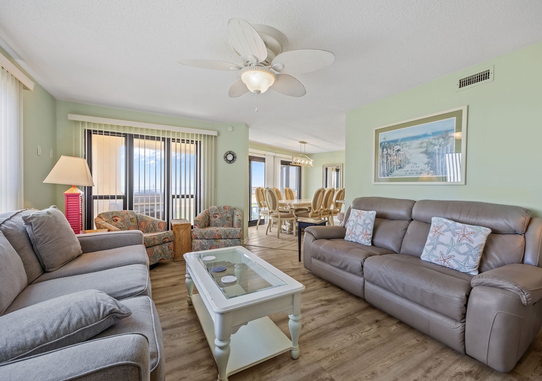 Relax in your spacious living room with comfortable seating and soothing coastal vibes that create the perfect vacation atmosphere.
