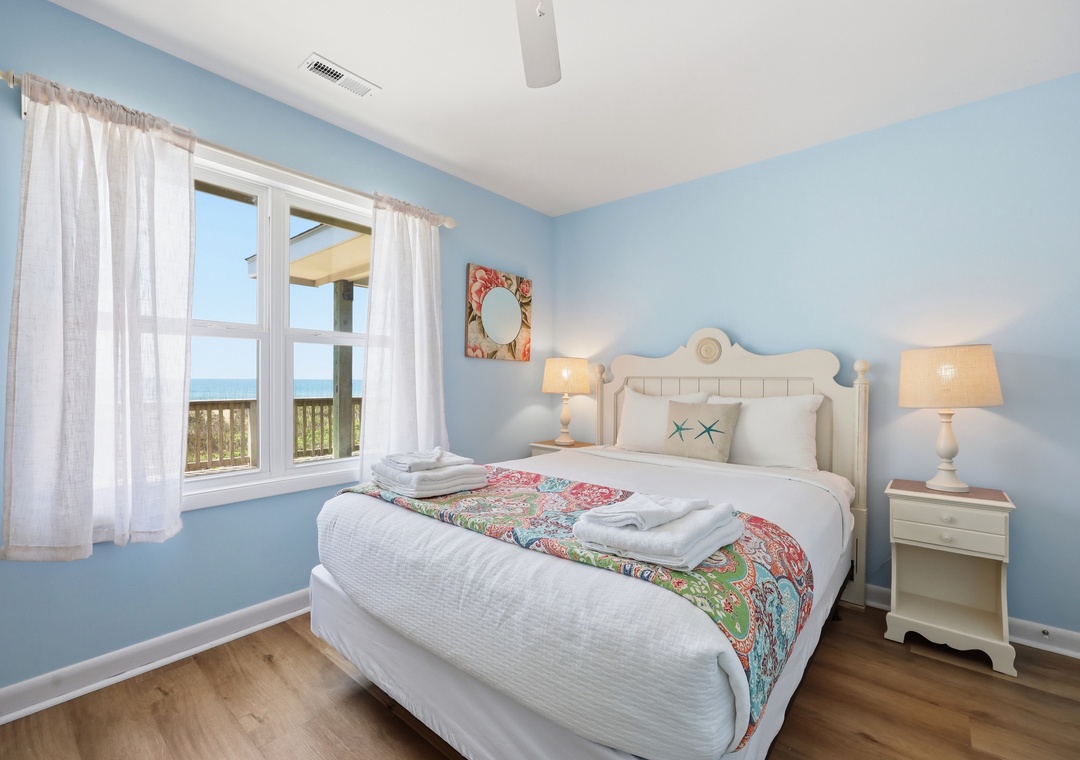 Wake up to stunning ocean views from your serene coastal retreat. Soft blue hues and crisp linens create a calming oasis where you can unwind and recharge by the sea.