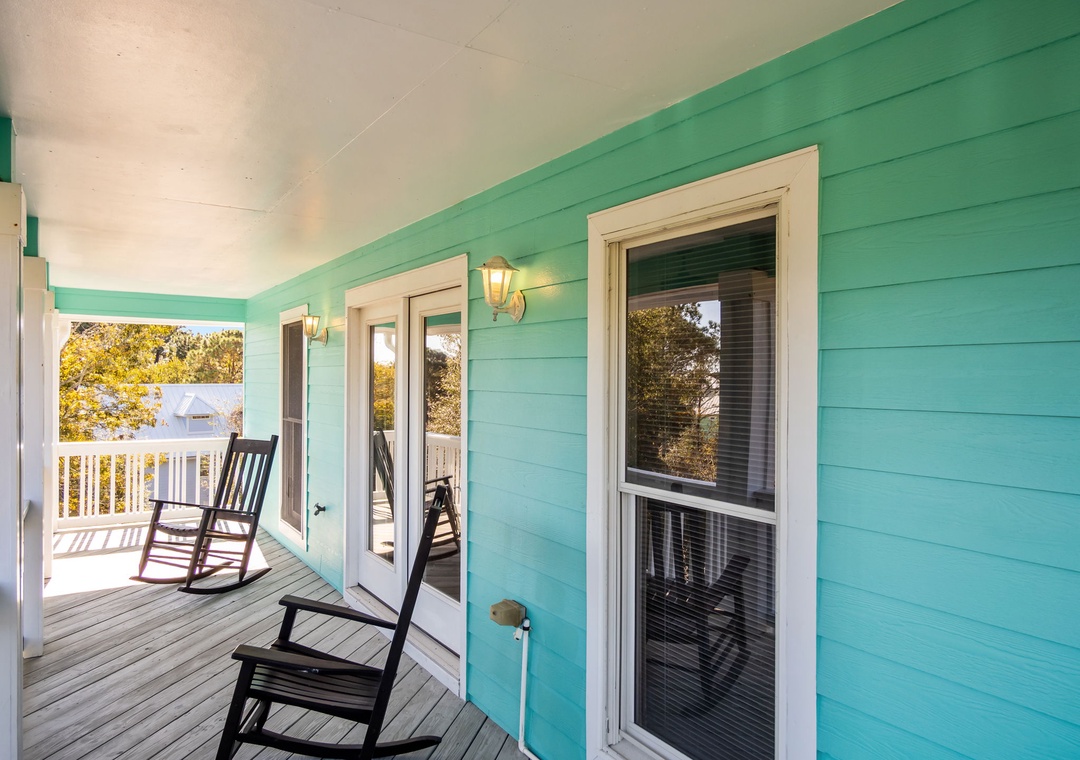 Unwind on your private porch with coastal-inspired turquoise walls and gentle rocking chairs that sway in the breeze.