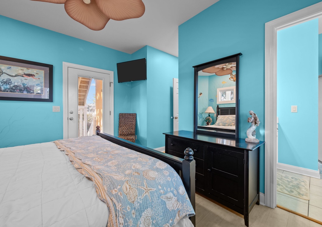 Drift off in your tropical-themed bedroom with ocean-blue walls and coastal touches creating a serene seaside retreat.