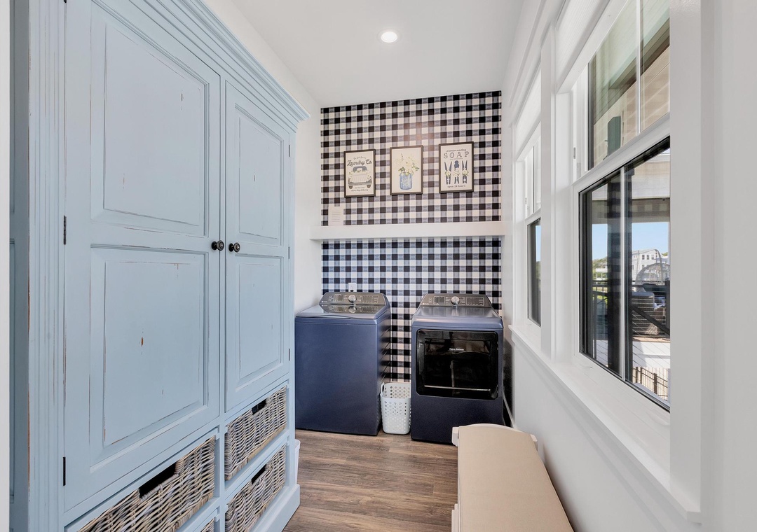 A dedicated laundry room with plenty of storage to keep your vacation wardrobe fresh. Gingham accents and practical appliances make this space both charming and functional.