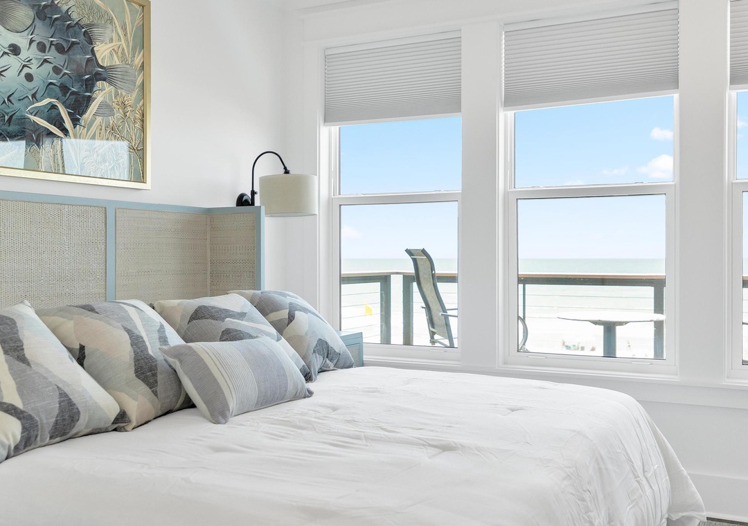 Wake up to ocean views from your bright, coastal-style bedroom. Soft linens and serene decor create the perfect beach escape.