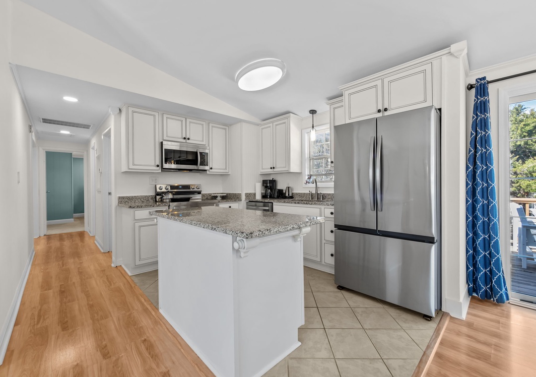 Your fully-equipped kitchen awaits with granite countertops, stainless appliances, and island perfect for morning coffee or meal prep.