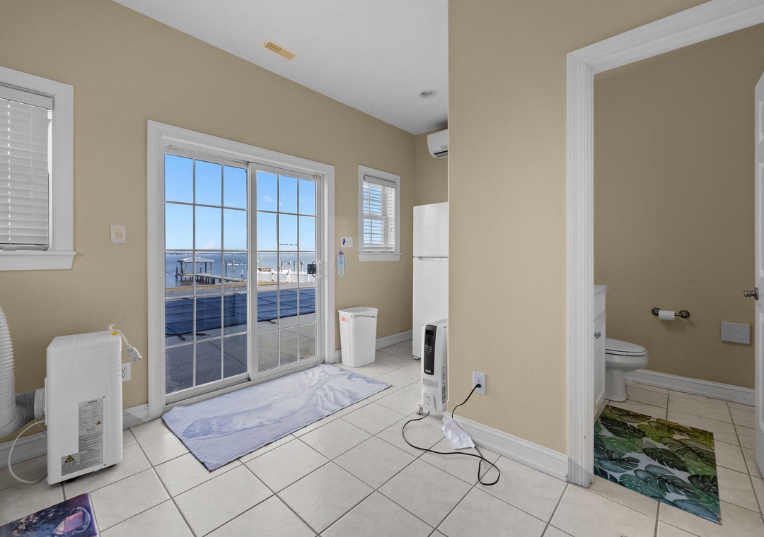 Refresh in your spacious bathroom featuring stunning water views through floor-to-ceiling windows and modern amenities for comfort.