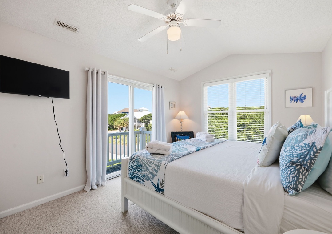 Drift off in this serene bedroom with calming coastal touches and natural light streaming through your private balcony doors.
