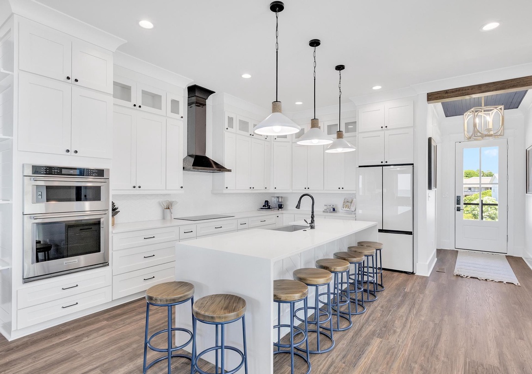 Step into your gourmet kitchen where crisp white cabinetry meets sleek countertops. Gather around the spacious island with friends and family, perfect for meal prep and morning coffee.