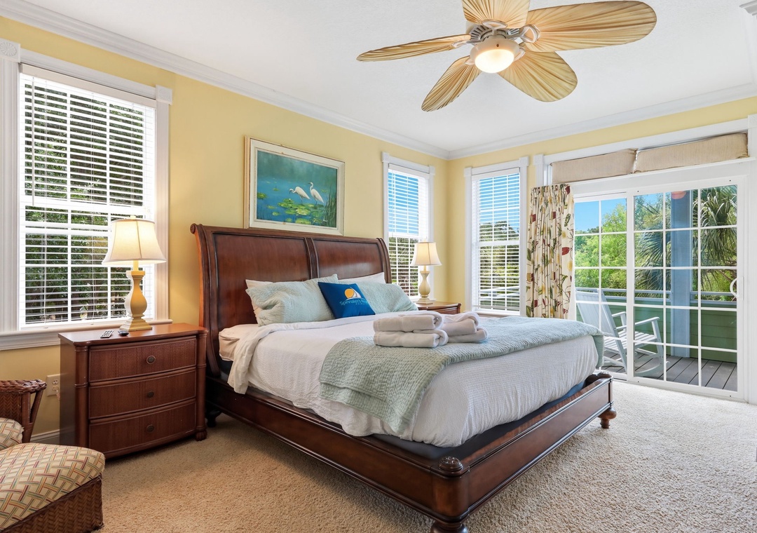 Sink into crisp linens and coastal calm in your sun-drenched bedroom, where French doors open to your private balcony and plush towels await your tropical escape.