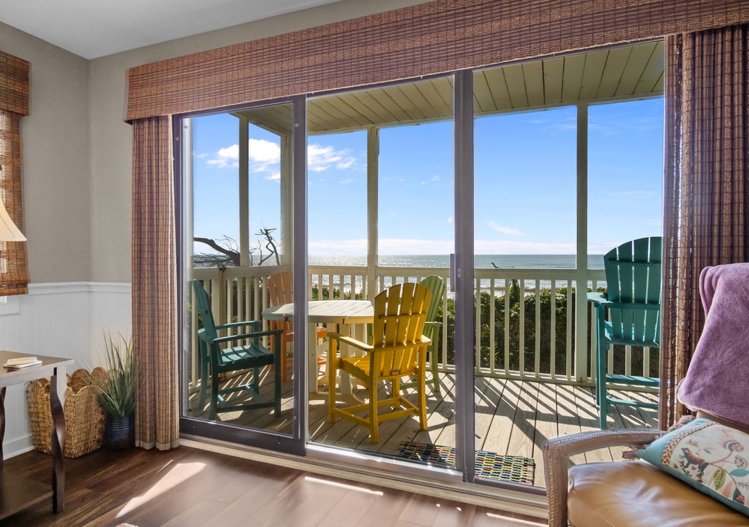 Step onto your private balcony where colorful beach chairs await, offering stunning sea views perfect for morning coffee or sunset relaxation.