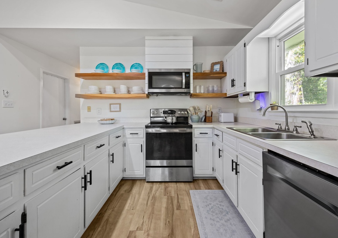 Your bright, fully-equipped kitchen invites culinary adventures with modern appliances, ample counter space, and charming open shelving for easy meal prep.
