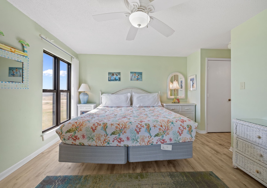 Drift off to sleep in your coastal-themed bedroom with soft linens and gentle sea breezes from your ceiling fan.
