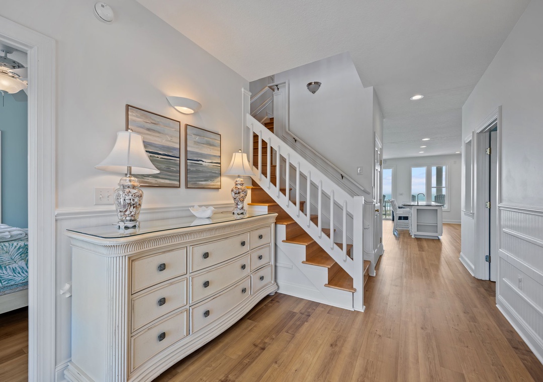 Step into your elegant coastal retreat with gleaming hardwood floors and crisp white details that create a fresh, airy atmosphere.