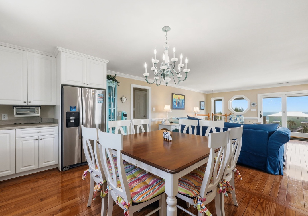Imagine preparing meals in this bright open kitchen while gazing at stunning ocean views. The spacious dining area flows into a cozy living room—perfect for gathering with loved ones after a day at the beach.